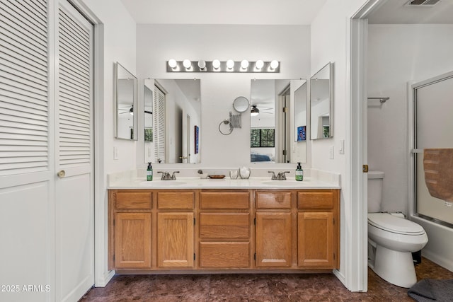full bathroom with vanity, ceiling fan, shower / bath combination with glass door, and toilet