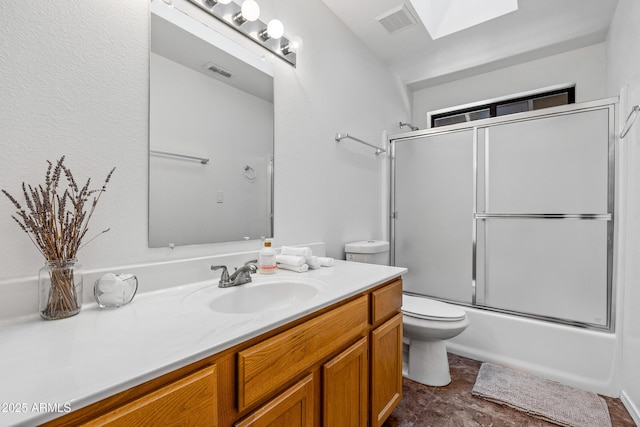 full bathroom with vanity, shower / bath combination with glass door, and toilet