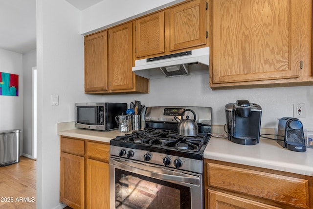 kitchen with stainless steel appliances and light hardwood / wood-style flooring