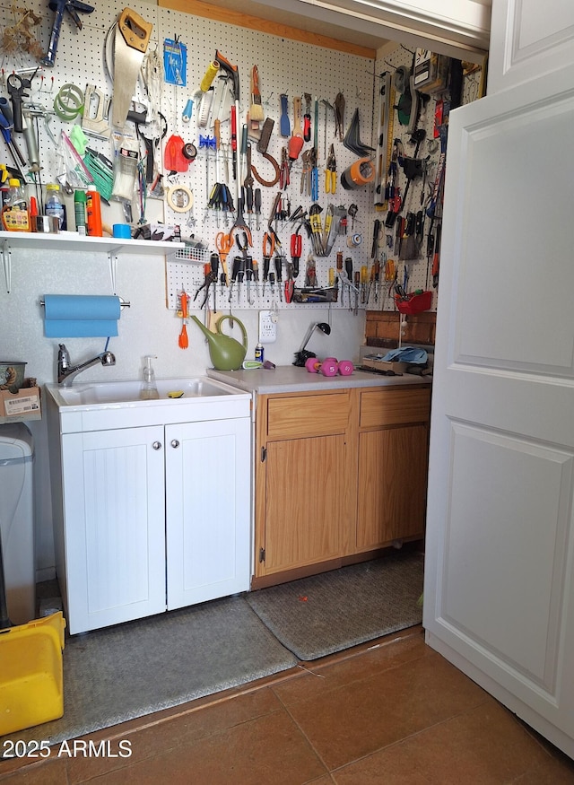 laundry room featuring a workshop area and sink