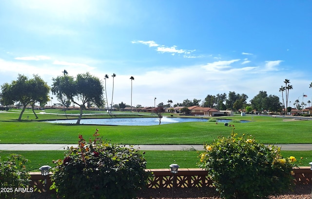 view of property's community with a water view and a yard