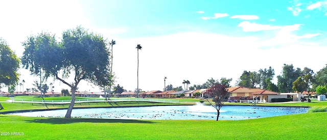 view of home's community with a yard and a water view