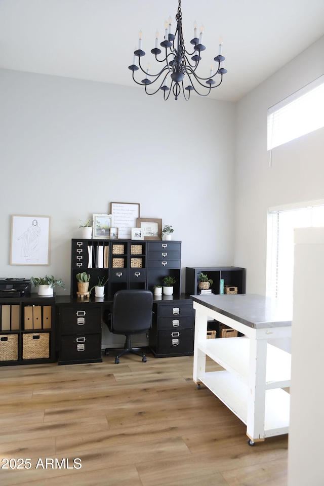 home office featuring hardwood / wood-style floors and a chandelier