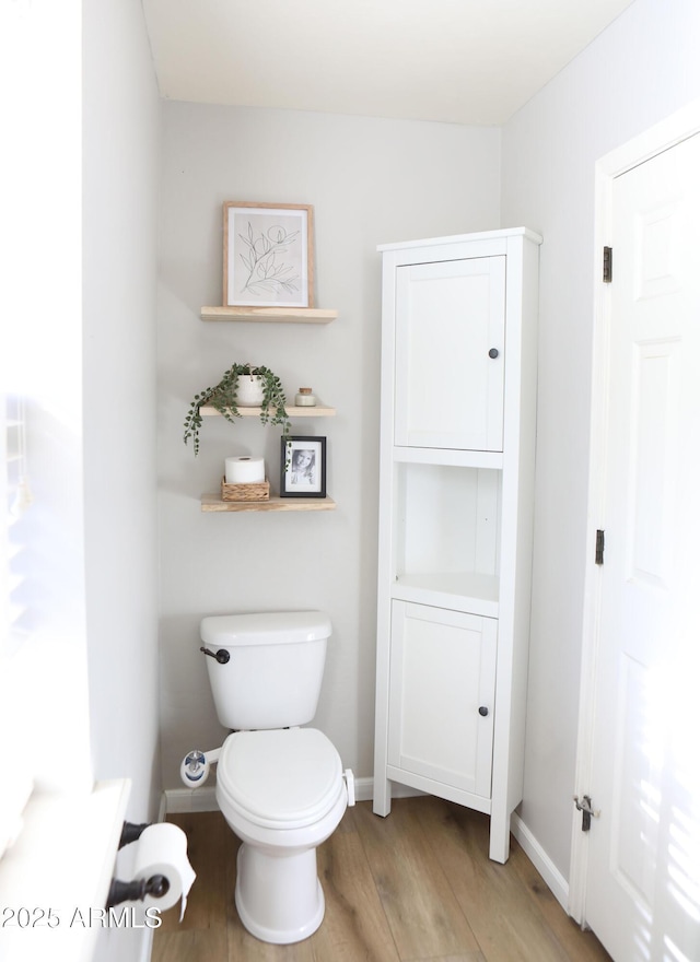 bathroom with toilet and wood-type flooring