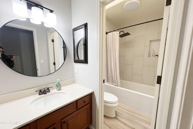 full bathroom featuring toilet, shower / bath combination with curtain, wood-type flooring, and vanity