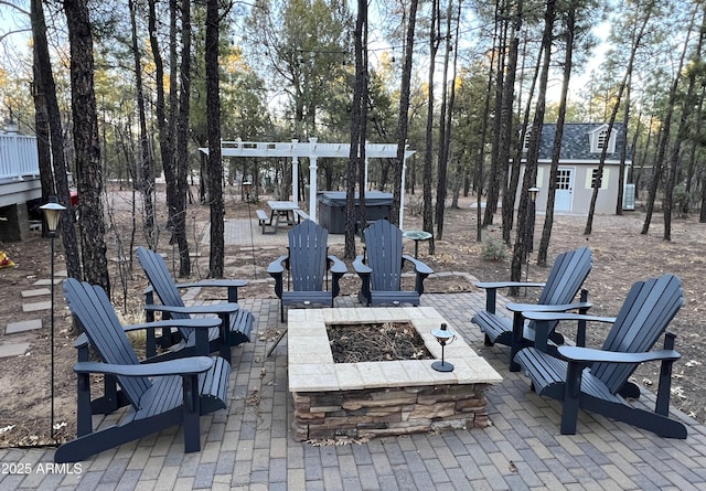 view of patio / terrace featuring an outbuilding and a fire pit