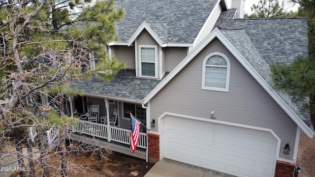 view of front of property featuring a garage and a porch