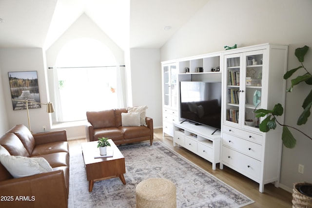 living room with hardwood / wood-style flooring and vaulted ceiling