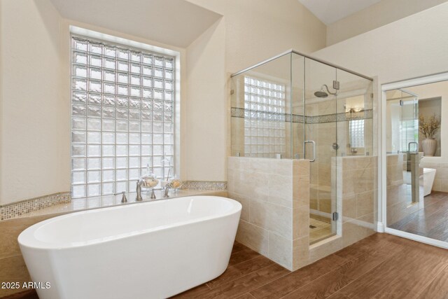 4960 E Dale Ln, Cave Creek, AZ 85331 - bathroom featuring wood finished floors, a freestanding tub, a stall shower, plenty of natural light, and tile walls