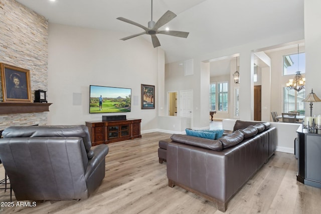 4960 E Dale Ln, Cave Creek, AZ 85331 - living room with high vaulted ceiling, light wood-style floors, a ceiling fan, and a chandelier