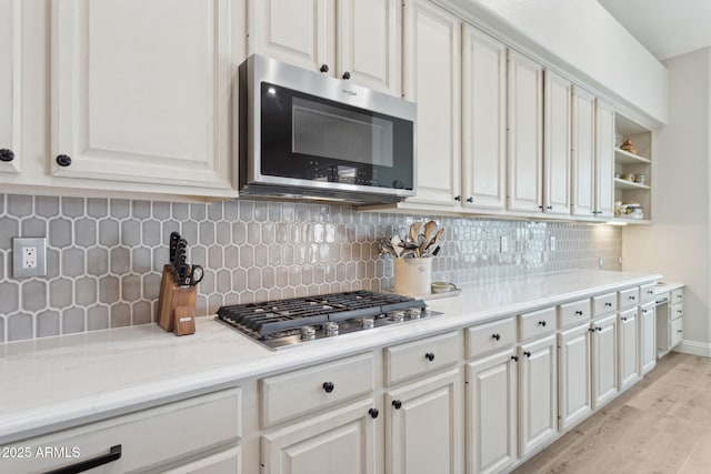 4960 E Dale Ln, Cave Creek, AZ 85331 - kitchen featuring appliances with stainless steel finishes, light wood-type flooring, backsplash, white cabinets, and open shelves