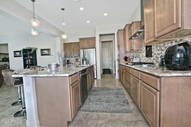 kitchen featuring pendant lighting, a large island, a kitchen bar, and stainless steel appliances