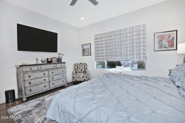 bedroom with dark hardwood / wood-style floors and ceiling fan