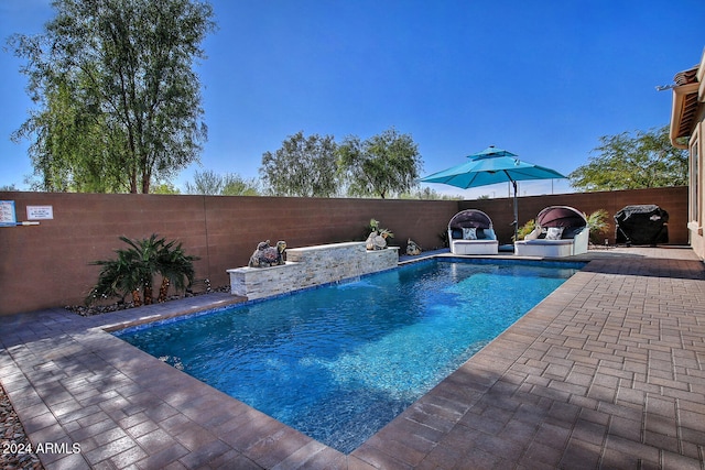 view of swimming pool with a patio area and pool water feature