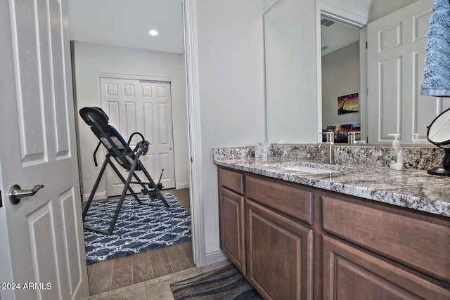 bathroom featuring wood-type flooring and vanity