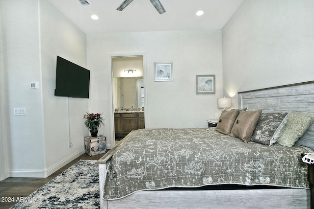 bedroom featuring dark hardwood / wood-style floors, ceiling fan, and ensuite bathroom