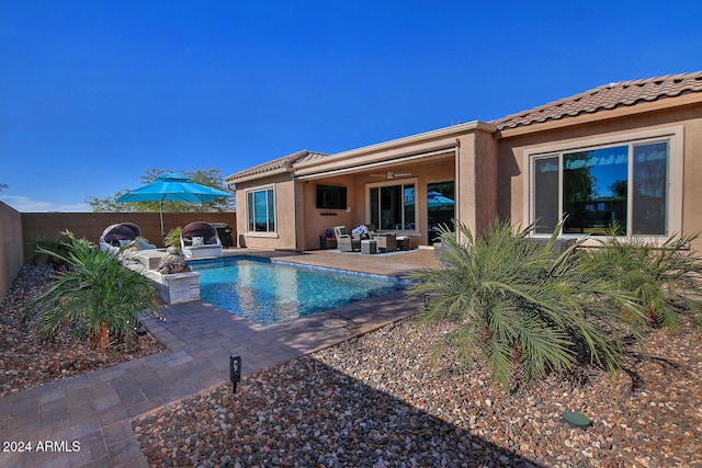 view of swimming pool with ceiling fan and a patio area