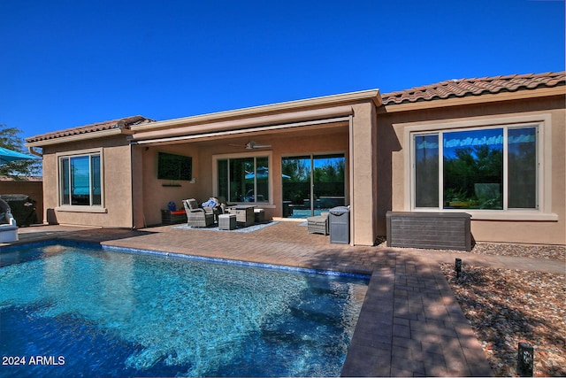 back of house with an outdoor hangout area, ceiling fan, and a patio area