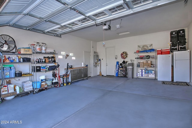 garage with a garage door opener and white refrigerator