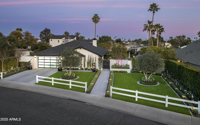 view of front facade featuring a garage and a lawn