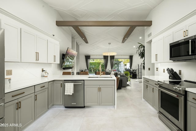 kitchen with sink, gray cabinets, white cabinetry, stainless steel appliances, and kitchen peninsula