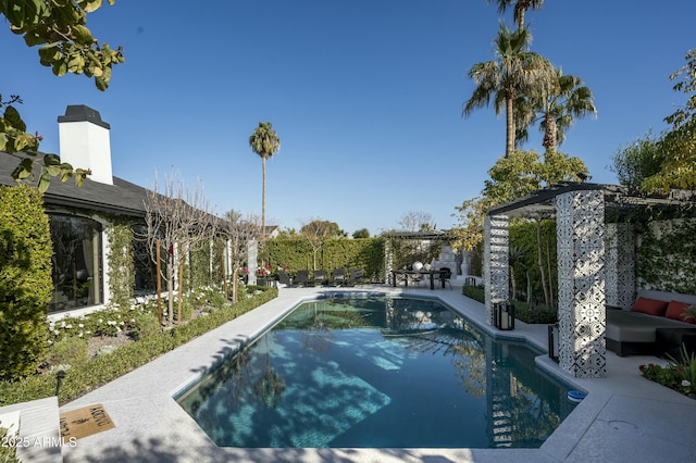 view of swimming pool with a pergola and a patio