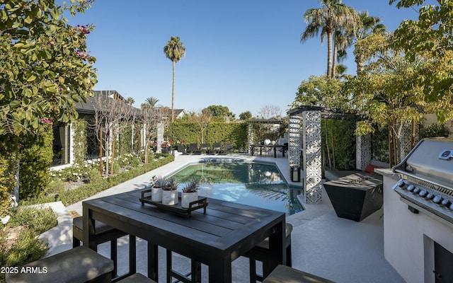 view of patio / terrace featuring area for grilling and a fenced in pool