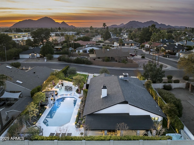 aerial view at dusk featuring a mountain view