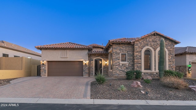 mediterranean / spanish-style home featuring a garage