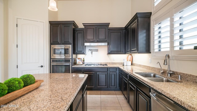 kitchen featuring light tile patterned flooring, appliances with stainless steel finishes, plenty of natural light, and sink