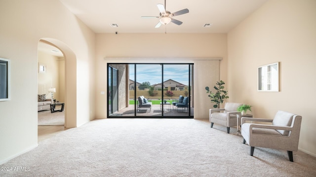 living area featuring ceiling fan and light colored carpet