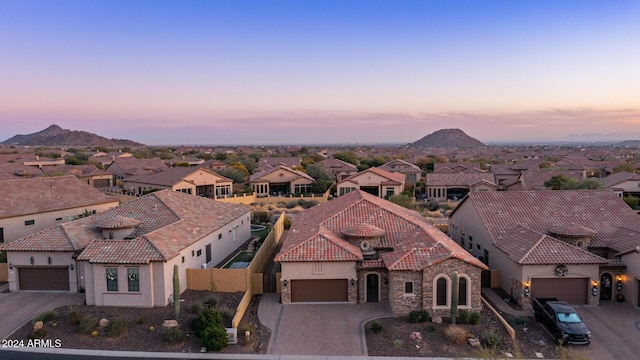 aerial view at dusk featuring a mountain view