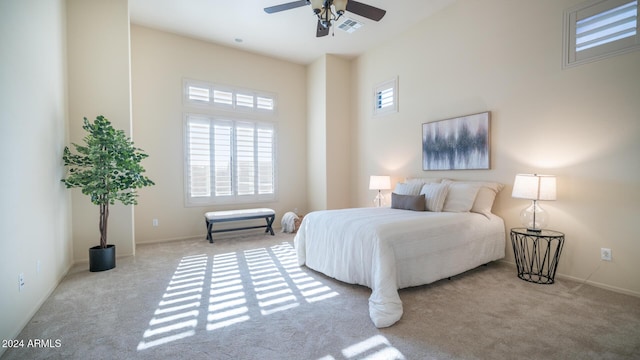 bedroom with ceiling fan and light colored carpet