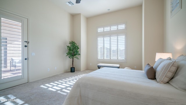 bedroom with light carpet, access to outside, and multiple windows