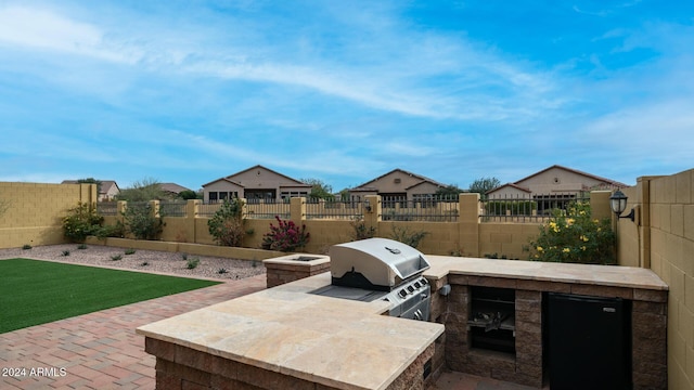 view of patio / terrace with an outdoor kitchen and grilling area