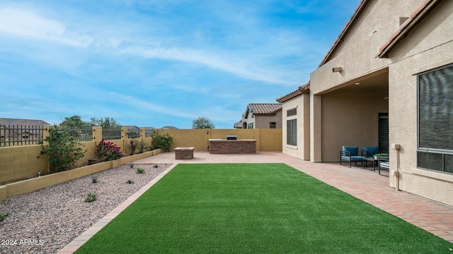 view of yard featuring an outdoor living space with a fire pit and a patio area