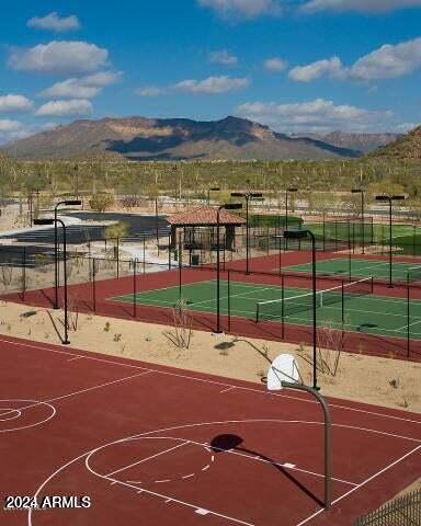 view of sport court featuring a mountain view and tennis court