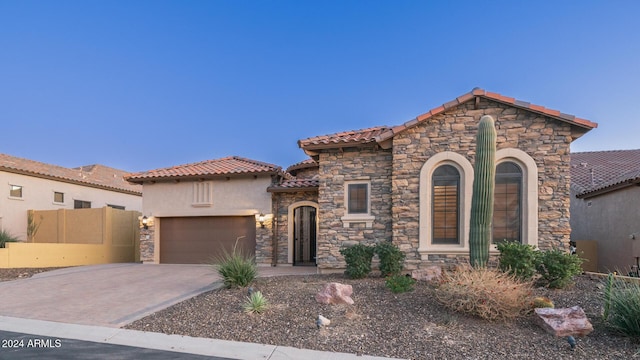 mediterranean / spanish-style home with a garage