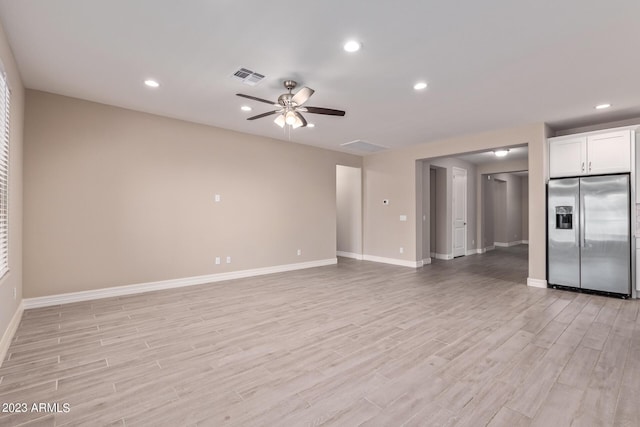 unfurnished living room featuring ceiling fan and light wood-type flooring