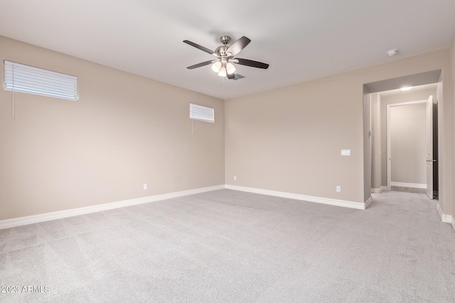 unfurnished room featuring light colored carpet and ceiling fan