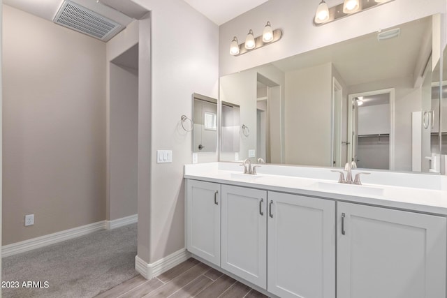 bathroom with hardwood / wood-style floors and vanity