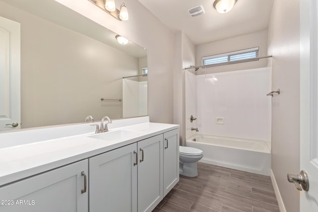 full bathroom with hardwood / wood-style floors, vanity, toilet, and shower / bathing tub combination