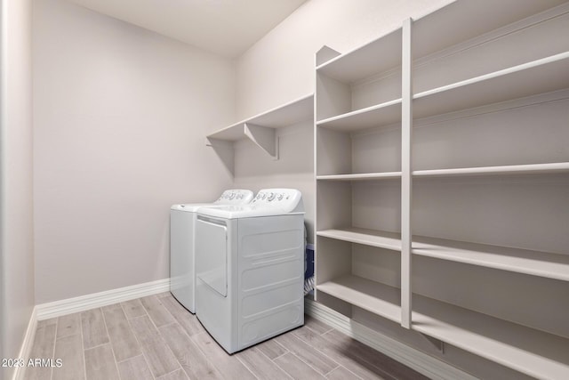 laundry room featuring wood-type flooring and washing machine and clothes dryer