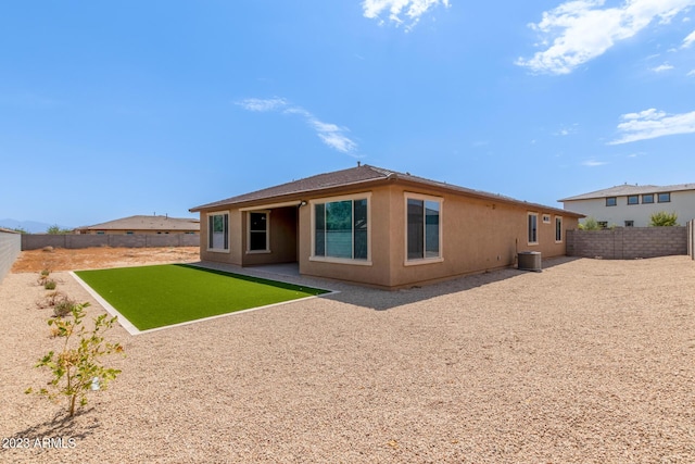 rear view of property with a lawn and a patio