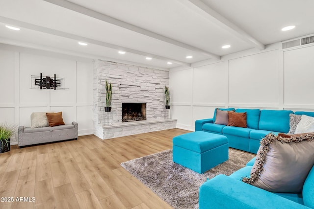 737 E 7th Pl, Mesa, AZ 85203 - living room with a decorative wall, beamed ceiling, light wood-type flooring, a fireplace, and recessed lighting