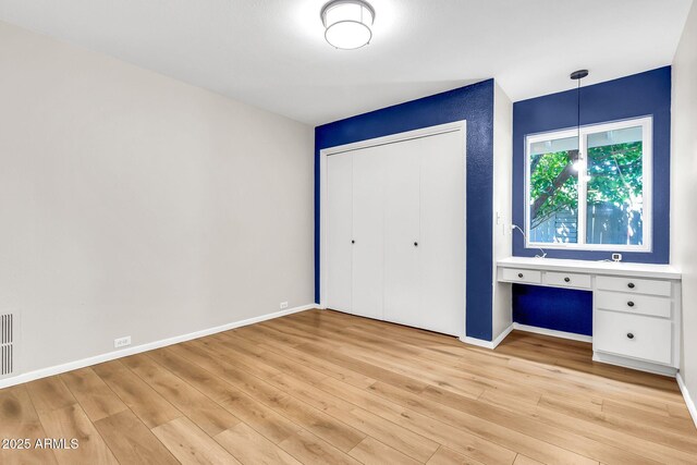 737 E 7th Pl, Mesa, AZ 85203 - unfurnished bedroom with light wood-style floors, a closet, and baseboards