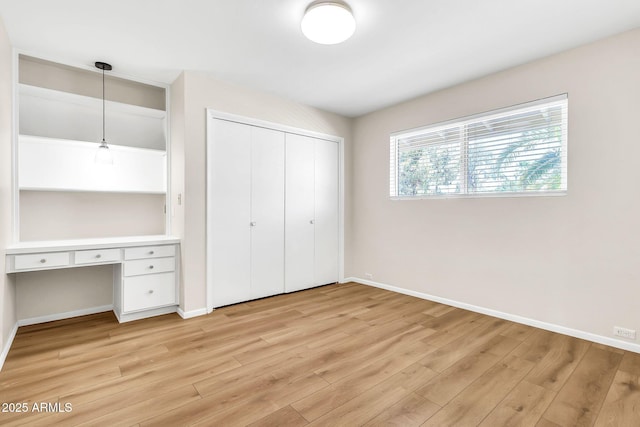 737 E 7th Pl, Mesa, AZ 85203 - unfurnished bedroom with light wood finished floors, baseboards, and a closet