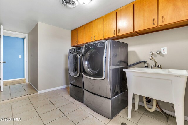 737 E 7th Pl, Mesa, AZ 85203 - clothes washing area with cabinet space, washer and clothes dryer, light tile patterned floors, and baseboards