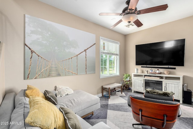 5612 S 21st Pl, Phoenix, AZ 85040 - carpeted living area with a ceiling fan, baseboards, and a glass covered fireplace