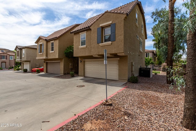 5612 S 21st Pl, Phoenix, AZ 85040 - view of front of property with stucco siding, an attached garage, and a tile roof